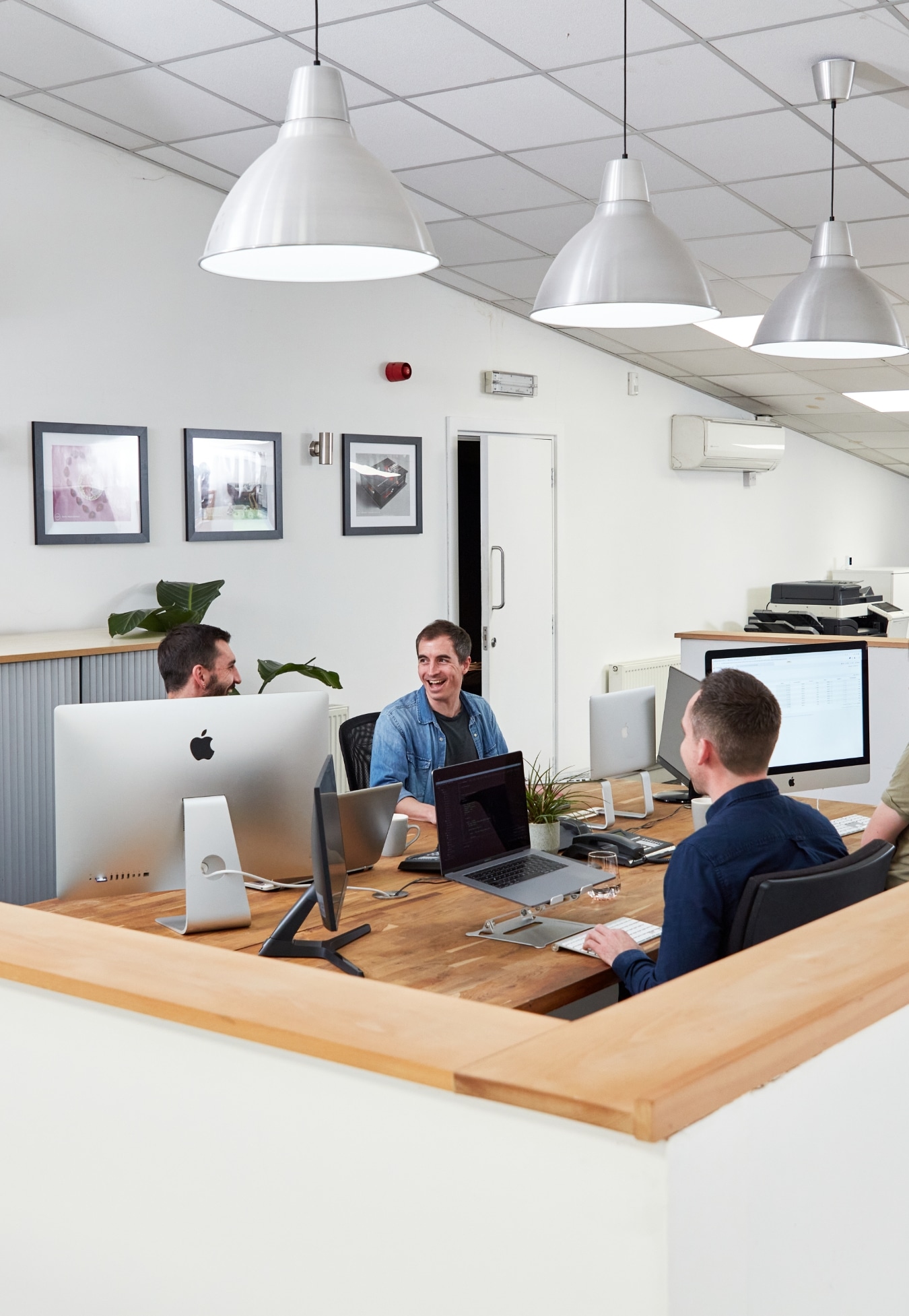 Four digital marketers in an office setting discuss conversion rate optimisation.