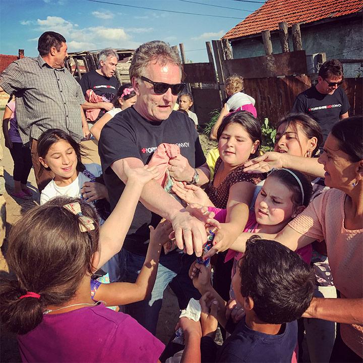 Yorkshire Aid Convoy with children, showcasing the humanitarian aspect of their work with a focus on helping children.