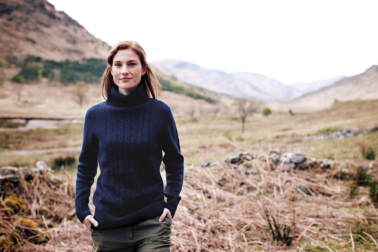 Location fashion photography image of a model walking through a hilly landscape.
