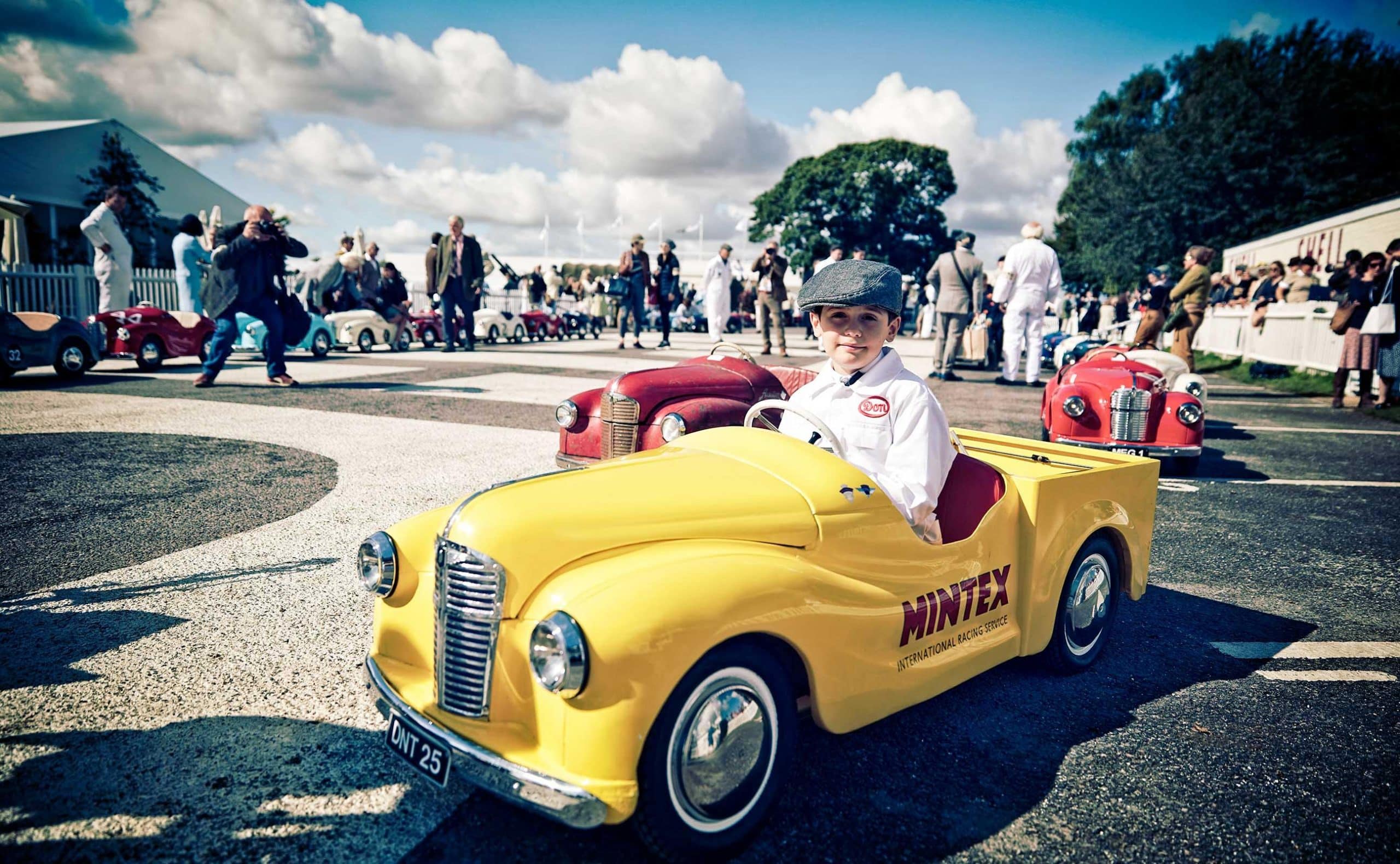 PR campaign for Mintex at Goodwood Revival 2017 a child drives a miniature vintage vehicle.
