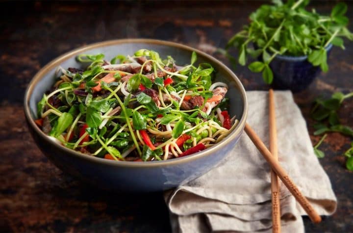 Stir-fried pea shoots highlighting fresh and vibrant food for high-quality food photography.