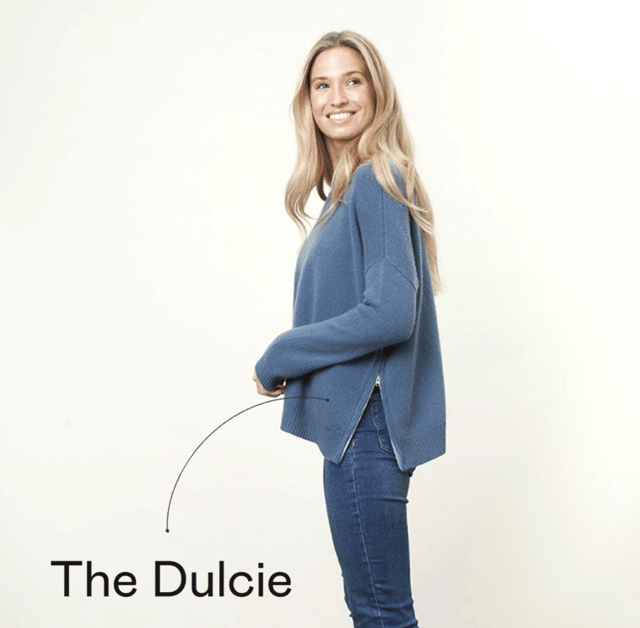 A model wearing a blue top and jeans, the image is branded The Dulcie.